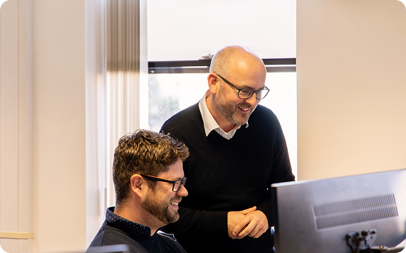 Mivida colleagues smiling at a screen
